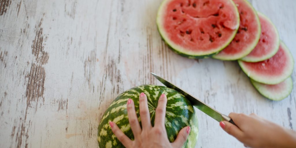 Woman slicing watermelon