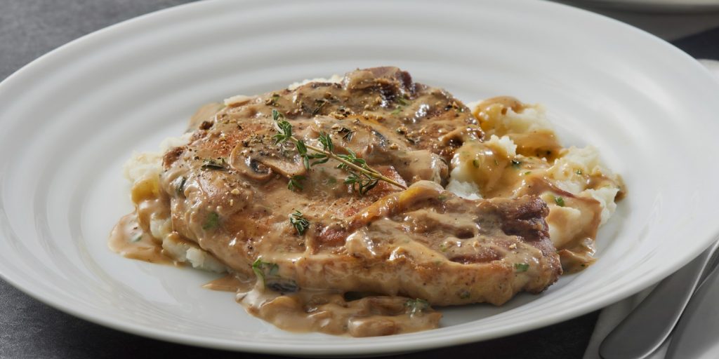 Braised Pork Chops in Creamy Mushroom Sauce on top of Egg Noodles