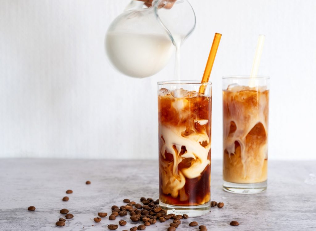 Pouring milk in cold brew coffee