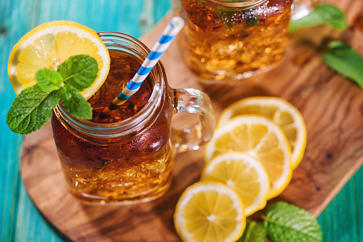 Freshly made iced tea with lemon and mint in a jar